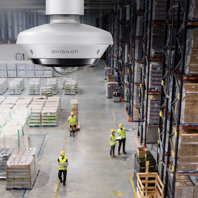 Avigilon H6A Dual Head Camera in a warehouse setting with workers.