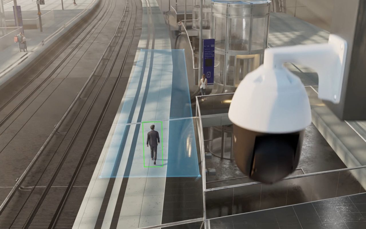 The main visual entity is a Pan-Tilt-Zoom (PTZ) security camera, specifically identified as a Verkada CP52-E, which is monitoring a train platform.